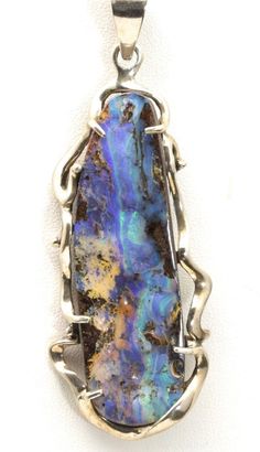 Artisan Modern Huge Boulder Opal Pendant-Handcrafted freeform, modern design Sterling silver setting-A very large, multi colored elongated oval boulder opal-Large bail will accommodate most chains with opening of 10mm x 8mm-Signed/Stamped "925" on the top of the bail, although it is difficult to read. Piece tests positive with silver acid test.-Pendant measures 3" long (not including the bail) x 1.3" wide, depth of pendant .35"-Opal stone measures 66mm x 20mm at the longest/widest points-Total w Boulder Opal Jewelry, Jewelry Pictures, Wire Wrap Jewelry Designs, Elongated Oval, Boulder Opal Pendant, Opal Pendant Necklace, Wrap Jewelry, Jewelry Picture, Stone Work