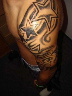 a man's arm with stars and swirls on the back of his body