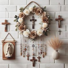 a wall with flowers and crosses hanging from it's sides next to a clock