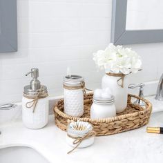 a bathroom sink with soap, toothbrushes and other items on the counter top