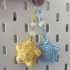 two crocheted key chains hanging from hooks