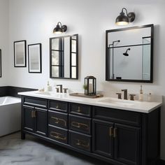 a bathroom with two sinks, mirrors and a bathtub in the middle of it