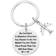 a keychain with an airplane on it that says be confident in whatever direction you choose to go for