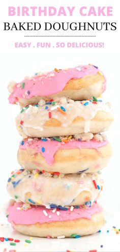 a stack of doughnuts with pink frosting and sprinkles