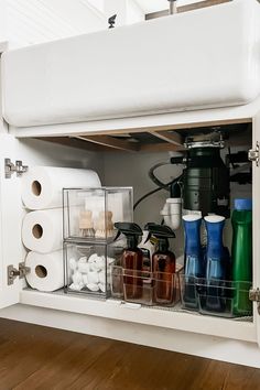 the kitchen cabinet is filled with various items