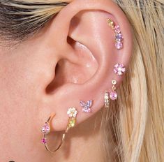 a close up of a woman's ear with flowers on the inside of it