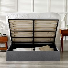 a bed that has some pillows in it