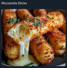 mozzarella sticks with melted cheese and herbs on top, sitting on a plate