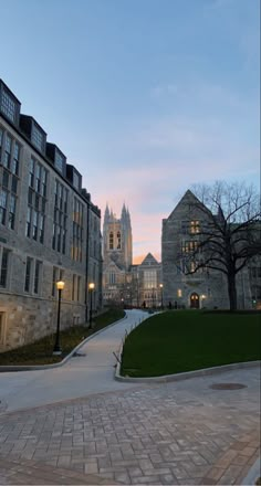 an old castle like building is lit up at dusk