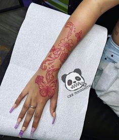 a woman with tattoos on her arm and hand