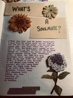 an open notebook with flowers and writing on it that says what's a soulmate?