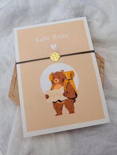 a card with an image of a bear holding a backpack on it's back