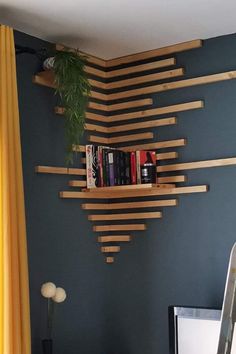 a bookshelf made out of wooden planks in the corner of a room