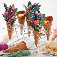 there are ice cream cones with flowers in them