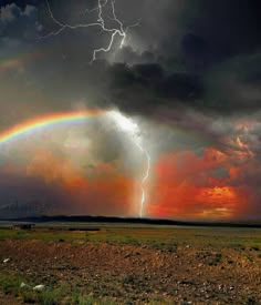 a rainbow appears to be in the sky over a field