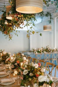 a long table with flowers and candles is set up for a formal dinner or party