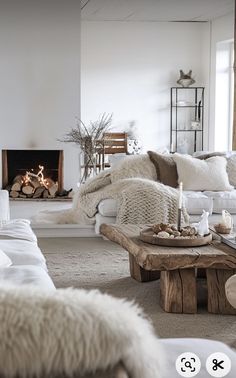 a living room filled with furniture and a fire place next to a fireplace in a white wall