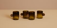 three brown glass cups sitting on top of a table