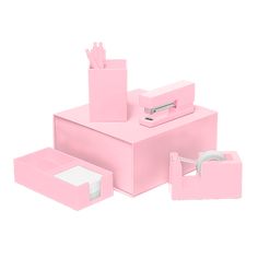 a pink desk set with tissue, pencils and pen holder