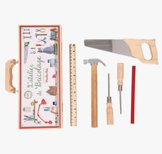 the tools needed to make a wooden toy set are displayed in a box, including a ruler