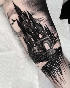 a man's arm with a castle tattoo on it