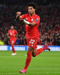 a soccer player is running on the field with his foot in the air as he prepares to kick the ball