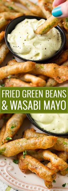 fried green beans and wasabi mayo on a white plate with a hand dipping it into a bowl