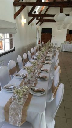 a long table set up with plates and place settings for an event or wedding reception