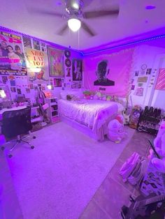 a bedroom with purple lighting and pictures on the wall