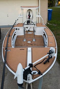 a boat is parked in front of a house with a water hose attached to it