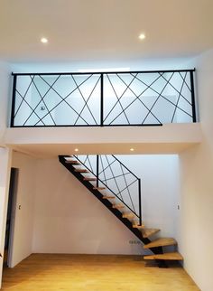 an empty room with stairs leading up to the second floor