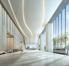 an empty lobby with large windows and plants in the corner on either side of it