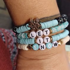 three bracelets with words on them that say let it snow