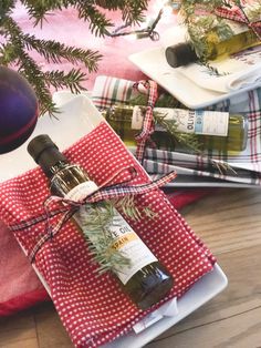 a bottle of olive oil wrapped in red and white checkered paper on a table