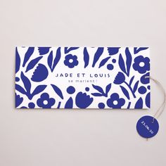 a blue and white floral business card with a tag on the front that says jade et louis