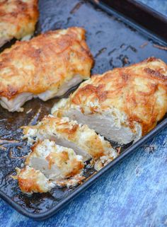 mayo parmesan crusted chicken shown sliced on a baking sheet