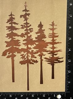 a ruler is next to some cut out trees