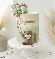 a teddy bear sitting on top of a cake