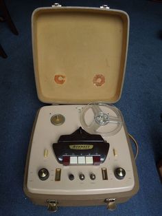 an electronic device in a case on the floor next to a blue carpeted floor