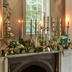 a mantel with candles and decorations on it