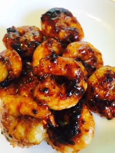 grilled shrimp with barbecue sauce on a white plate