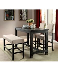 a dining room table with two chairs and a bench in front of the table,