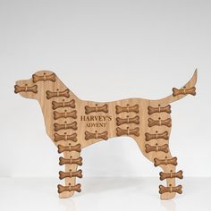 a wooden toy dog with bones on it's back and name that says harvey's adventure