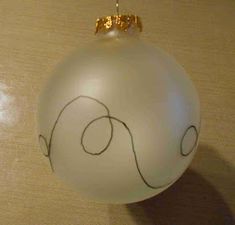 a white ornament hanging from a wooden table