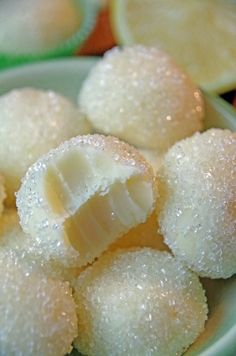 some food that is on a plate with lemons in the background and water droplets all over it