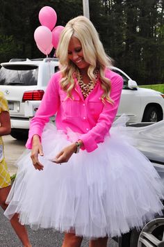 a woman in pink shirt and white tutu skirt