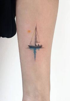 a small sailboat tattoo on the right inner arm and leg, with an orange sun in the background