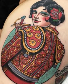 a woman's thigh with tattoos on it and an image of a geisha