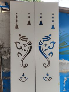 two white and blue doors with designs on them