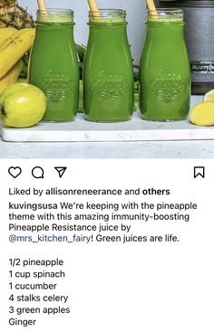 green juice in mason jars on a shelf with bananas and limes next to it